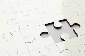 Fototapeta premium White puzzle with missing piece on grey background, closeup