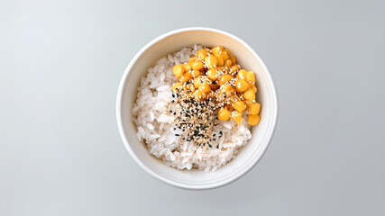 Bowl of rice topped with corn and black sesame seeds, a simple and nutritious meal