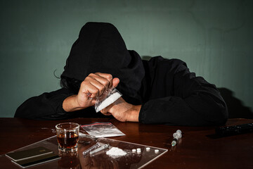 Man hand holds plastic packet drugs or bag with cocaine, drug abuse and danger addiction concept