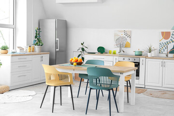 Interior of white kitchen with citruses on table