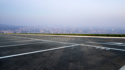 Fototapeta premium Tranquil Overlook: A Peaceful Parking Lot with Scenic City View