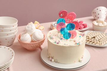 Cake with sweets for birthday party on pink table