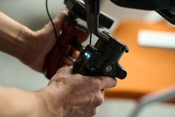 Close-Up of Videographer Operating Gimbal Camera