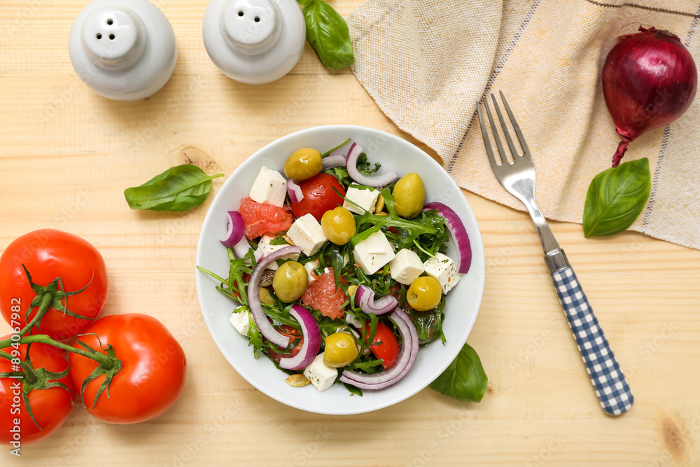 Wall mural bowl with healthy vegetable salad, fork and ingredients on wooden background