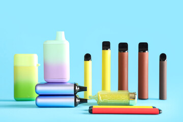 Different electronic cigarettes on blue background
