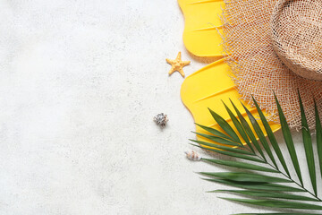 Beautiful composition with hat, palm leaf, flippers and starfish on white grunge background © Pixel-Shot