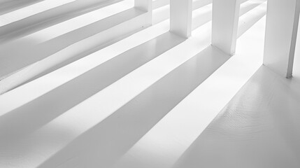 Striped light and shadow patterns on a white indoor architectural space, representing modern design and elegance