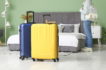 Suitcases and young woman at home. Travel concept