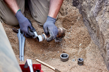 A Plumber hooking up a temporary gas line to a propane tank