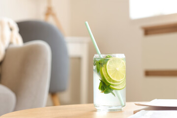 Glass of tasty mojito on table at home