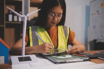 Female architect working at home She looked at the blueprint.