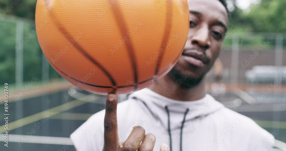 Sticker Sports man spinning a basketball on his finger while standing in the outdoor playing court. Fitness, exercise and healthy black athlete training his hand skills for a game at a professional field.