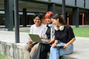 Group of Diverse Students Studying Together Outdoors with Laptops and Notebooks, Engaged in Collaborative Learning