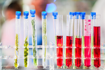 scientific tubes containing rare chemicals and exotic plant samples are used to extract substances...
