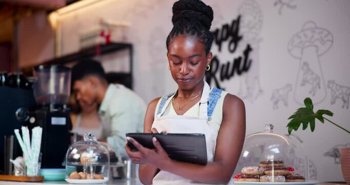 Tablet, ecommerce and black woman in coffee shop for online order in small business startup as owner or employee. Tech, inventory and young waitress or barista in cafe for hospitality and service