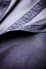 Close up of dark Men's shirt. Soft focus. Copy space.	