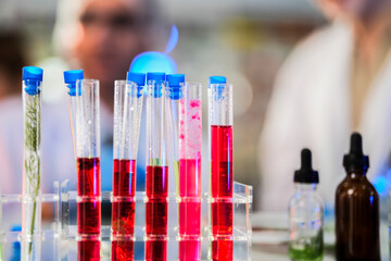 scientific tubes containing rare chemicals and exotic plant samples are used to extract substances...
