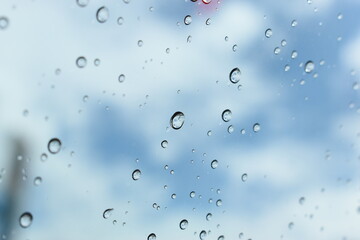 water drop on mirror with blue sky and white cloud background
