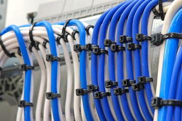 Plastic ties for tightening insulated copper electrical wires. Close-up. Soft focus.