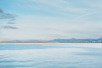 view of ocean and mountains with snow in winter at Aomori Bay Bridge Locate in the city of Aomori in Aomori Prefecture, Japan