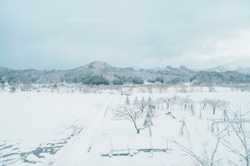 Landscape of mountain with snow in winter day. Photo from train window. Nature background