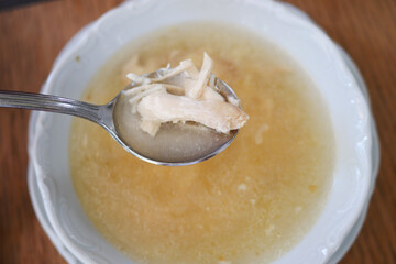 Bowl of chicken noodle soup on a wooden table