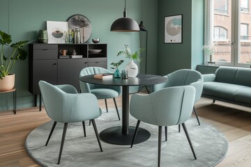 Stylish dining room interior with round black table and elegant blue chairs on soft rug.