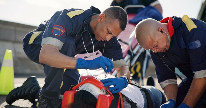 People, accident and emergency on road with flashlight for pupil response, head trauma or life support with check. Safety, first aid or health insurance or concussion injury on street, ems or crisis