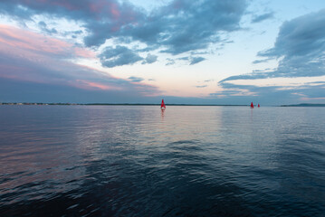 Red sailboat at sea sunset