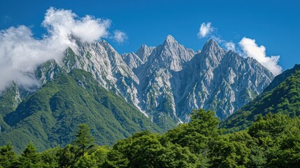 Fototapeta premium Majestic mountain range with towering peaks under blue skies - stunning landscape photography