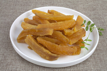 Close up of half-dried sweet potato with decoration leaf on whit dish and cloth, South Korea
