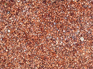 red stone pebbles background, top down view,