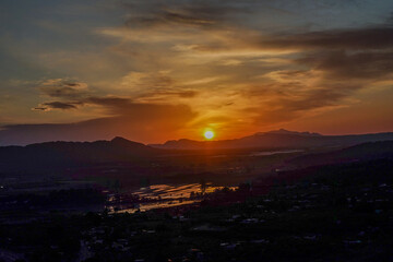 sunrise, with powerful orange colors, in a summer dawn, with the Calasparra rice fields reflected by the King star