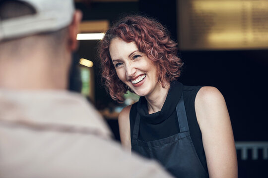 Courier, delivery and smile with woman hairdresser at door of salon for ecommerce or logistics. Customer satisfaction, retail and thank you with person greeting postal worker at entrance of store - Powered by Adobe