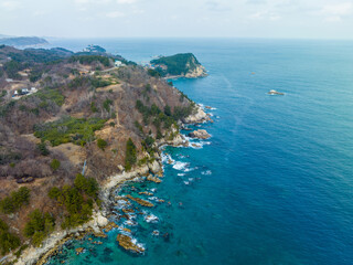 Aerial and afternoon view of wave on sea rocks at Haesindang Park of Sinnam in winter near Samcheok-si, South Korea
