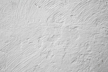 White paint and plaster grunge texture on a wall, abstract pattern backdrop with vignette, close up