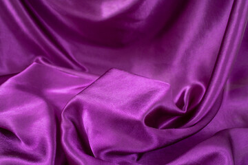 Purple color silky fabric with shiny waves and a square stage in the middle for product placement, creative product display backdrop