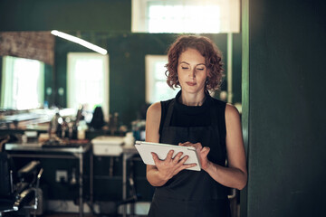 Technology, hairdresser or woman with tablet in salon for schedule, online appointment or calendar...