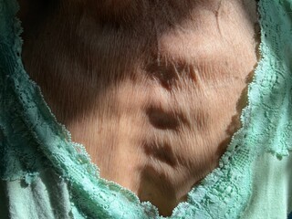 Close-up of an old woman's chest.