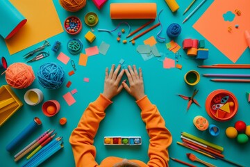 Child's Hands Resting on a Blue Table With Colorful Art Supplies