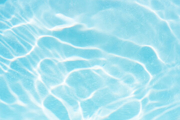 Blue water with ripples on the surface. Defocus blurred transparent blue colored clear calm water...