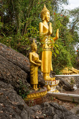 Luang Prabang, Laos: Wat Tham Phousi in the middle of mountain Mount Phousi contains a statue of...