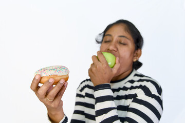 Woman caught between the sweet temptation of a donut