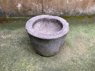 Mortar on a gray background. One of the traditional cooking utensils in Indonesia. Usually used to mash and puree cooking ingredients