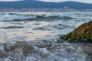 waves crash against the rocks on the seashore