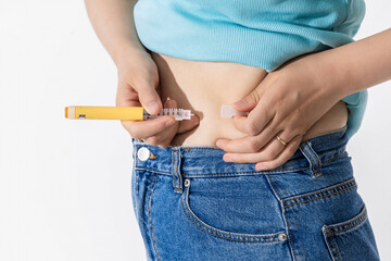 A woman injecting herself with obesity medication