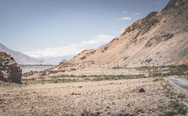The Panj River flows between Afghanistan and Tajikistan along the Pamir Highway road in the Tien Shan mountains
