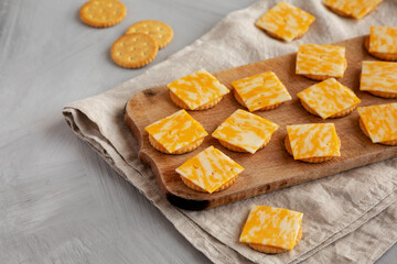Easy Cheese and Crackers on a wooden board, side view. Copy space.