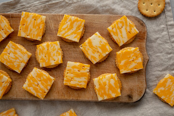 Easy Cheese and Crackers on a wooden board, top view. Flat lay, overhead, from above.