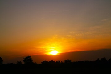 Sunset Sky Clouds in the evening with Red, Orange, Yellow and purple sunlight on Golden hour after sundown, Romantic sky in summer on Dusk Twilight. heart sky.